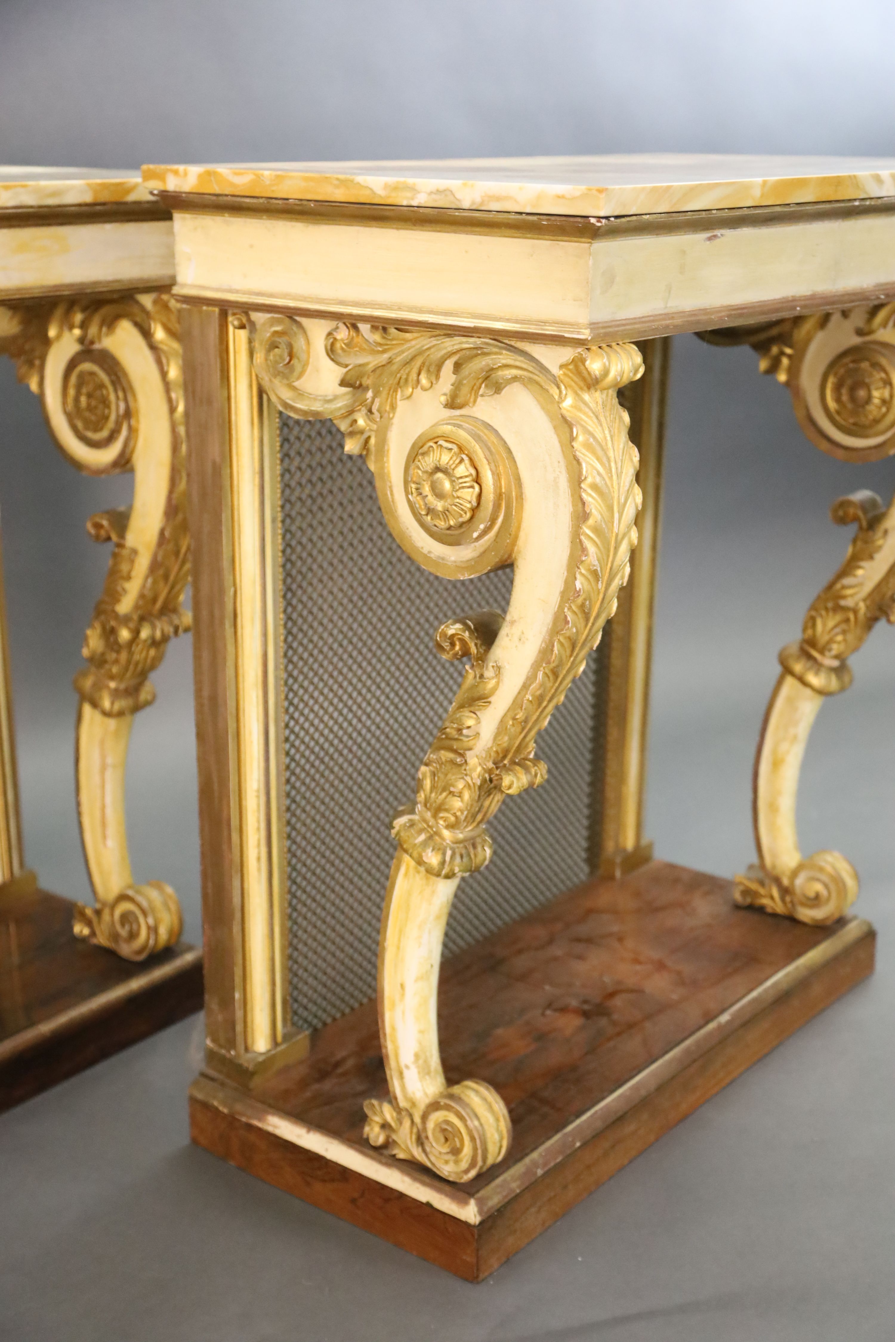 A pair of William IV parcel gilt cream painted and rosewood console tables, W.2ft 6in. D.1ft 6.5in. H.2ft 11.5in.
